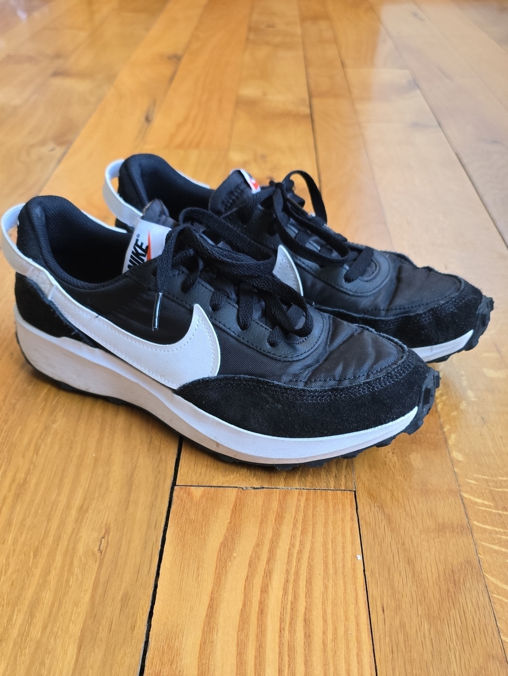 Nike Waffle Debut sneakers featuring a black nylon and suede upper with a white